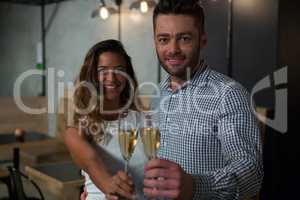 Portrait of happy couple holding champagne glass