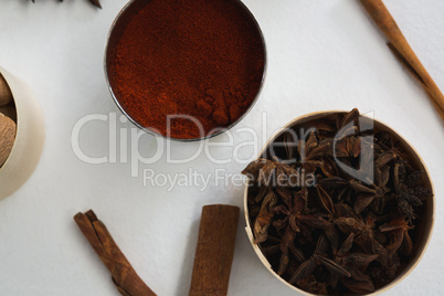 Star anise and chili powder in bowl with cinnamon stick