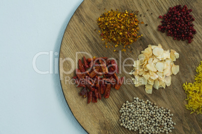 Various spices on wooden board