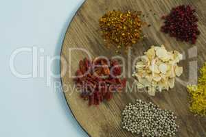Various spices on wooden board