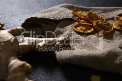 Ginger and dried orange sliced on textile