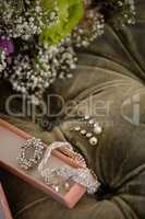 High angle view of bride jewelry on sofa