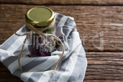 Pickled vegetables in jar with cloth