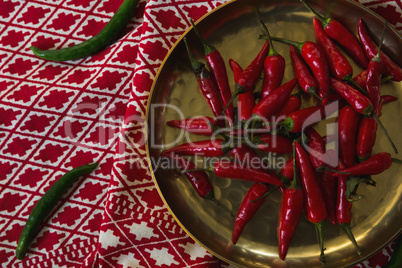 Red chilies in plate on table cloth
