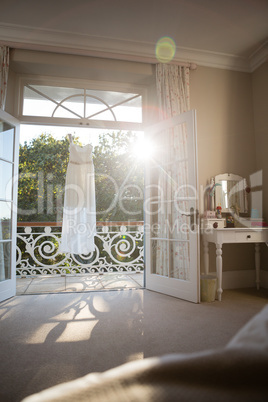 Wedding dress hanging in balcony