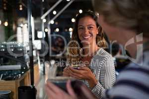 Happy woman interacting while having coffee