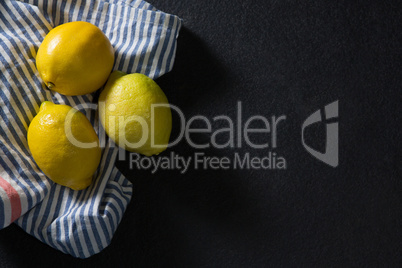 Three fresh lemons on textile