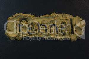 Fennel powder forming text fennel on black background
