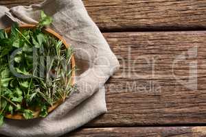 Fresh herbs in wooden plate