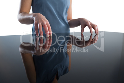 Mid section of businesswoman gesturing at table