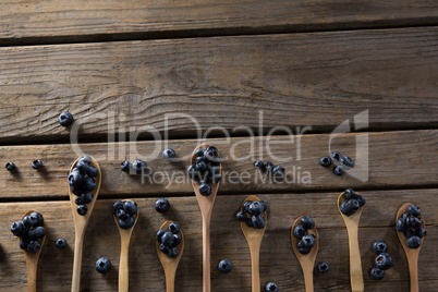 Blueberries in wooden spoon arranged on table