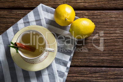 Cup of tea with lemon and cinnamon stick