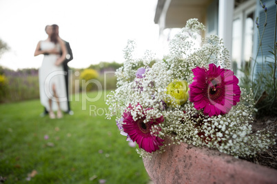 Close up of bouquet with romatic couple dancing in background