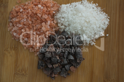 Various salts on chopping board
