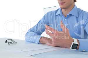 Mid section of businessman holding glass interface while working on documents