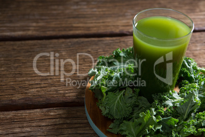 Mustard greens and juice on wooden board