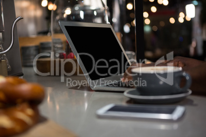 Man using laptop at table Man using laptop at table