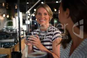 Happy woman interacting while having coffee