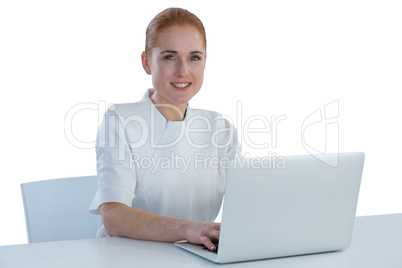 Portrait of young businesswoman using laptop computer