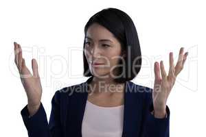 Businesswoman gesturing against white background