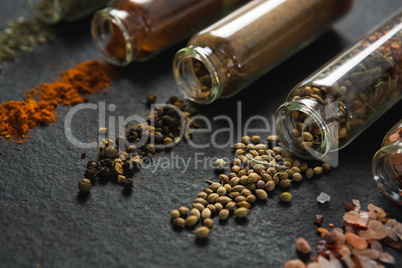 Various spices spilled out of jar
