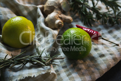 Sweet limes with rosemary and spices on table cloth