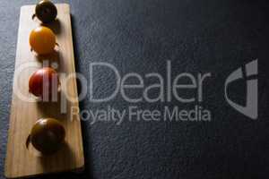 Various tomatoes arrange in wooden tray