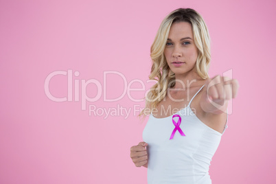Portrait of woman with Breast Cancer Awareness ribbon punching