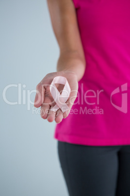 Mid section of female holding pink ribbon