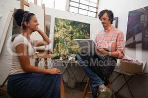 Man drawing a portrait of woman in drawing book