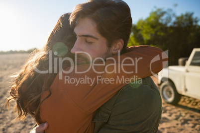 Young couple embracing on field