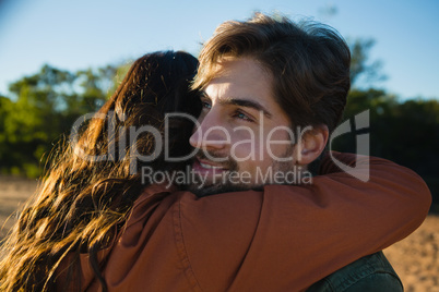 Man embracing woman on field