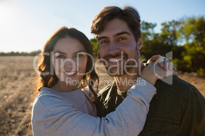 Portrait of smiling couple on landscape