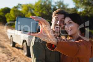 Happy woman taking selfie with man