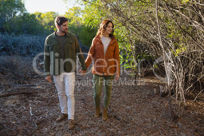 Couple holding hands on field