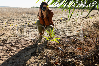 Woman photographing on landscape