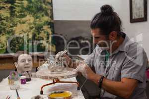 Attentive man molding clay