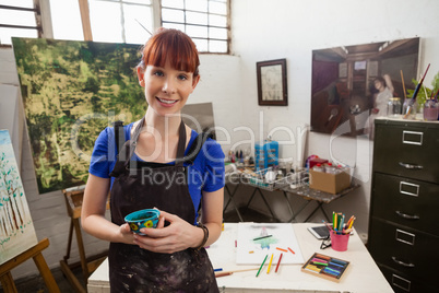 Portrait of beautiful woman holding painted bowl