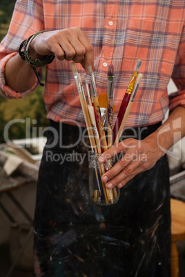 Man selecting a paintbrush