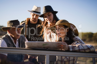 Friends looking at map in vehicle