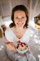 Portrait of happy woman having breakfast