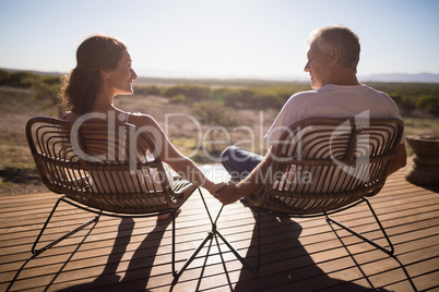 Senior couple sitting on chairs at the resort