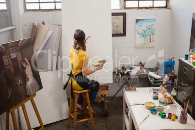 Woman painting on canvas