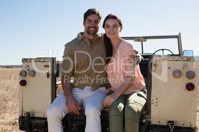 Portrait of young couple sitting in off road vehicle