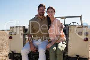 Portrait of young couple sitting in off road vehicle