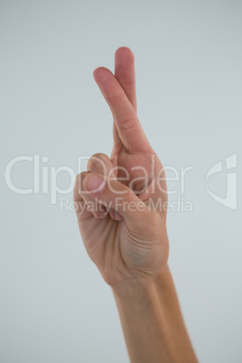 Cropped hand showing crossed fingers