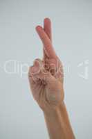 Cropped hand showing crossed fingers