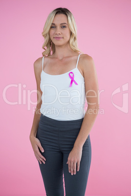 Portrait of happy young woman with Breast Cancer Awareness ribbon