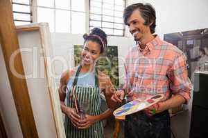 Man and woman looking at painting