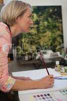 Woman drawing in drawing book